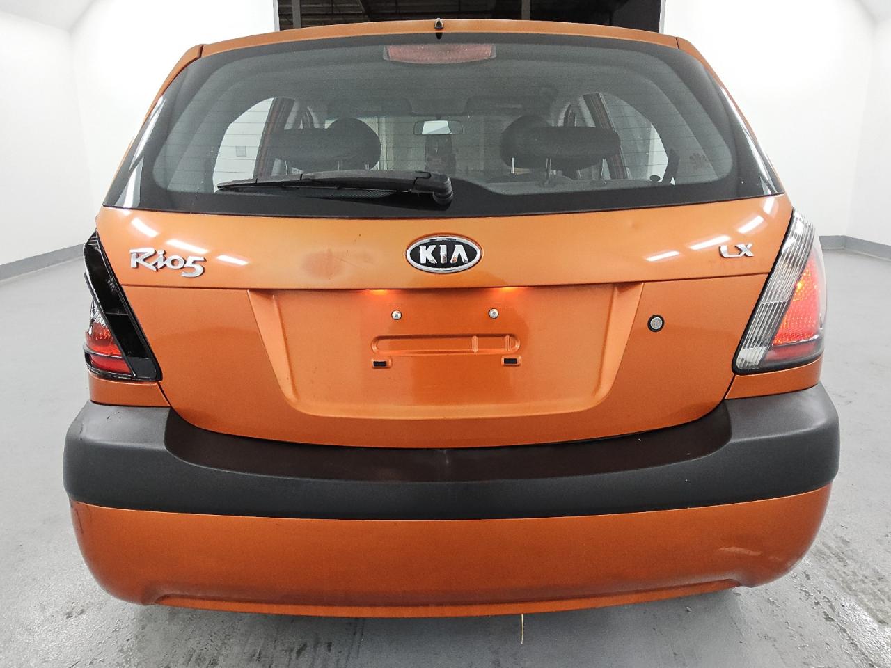 2009 Kia Rio5 Lx Orange vin: KNADE243896567101 Damage: Left Tail Light, Broken, Replacement Required