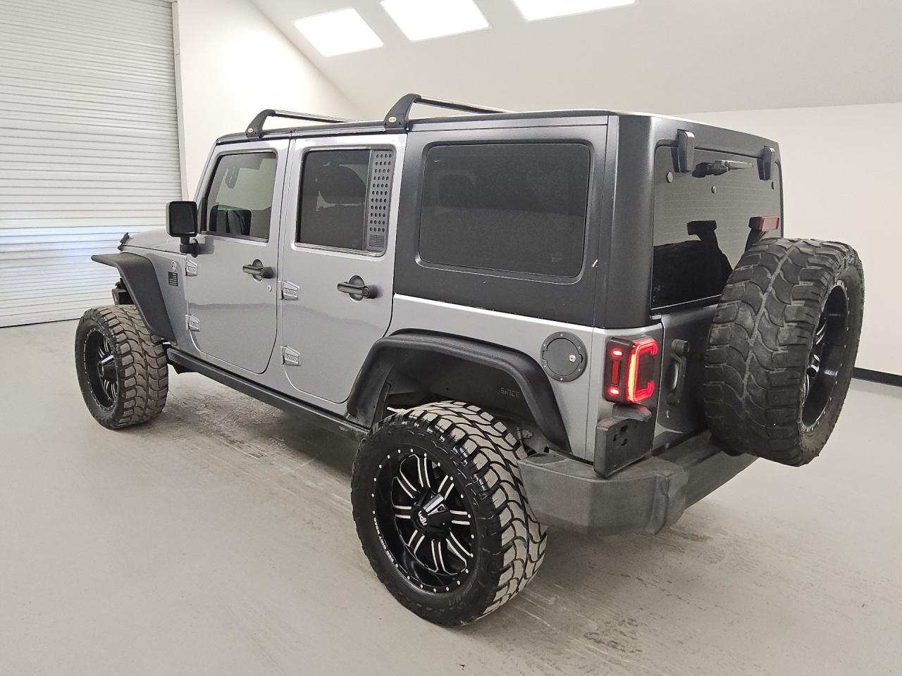 2015 Jeep Wrangler Unlimited Sport Silver vin: 1C4BJWDG5FL505104 Damage: Left Fuel Door, Aftermarket, Acceptable