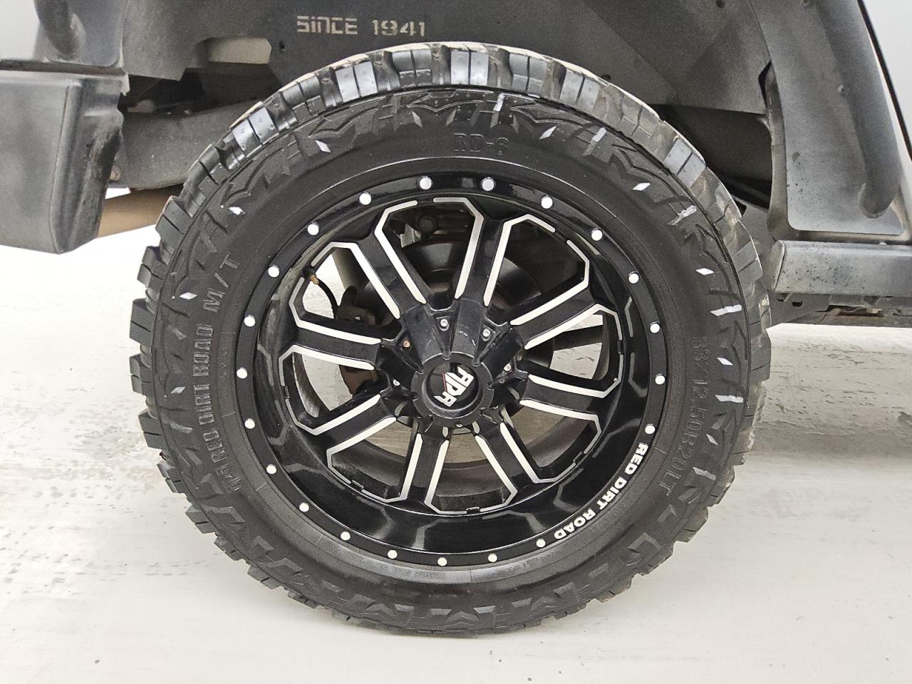 2015 Jeep Wrangler Unlimited Sport Silver vin: 1C4BJWDG5FL505104 Damage: Right Rear Wheel, Aftermarket, Acceptable