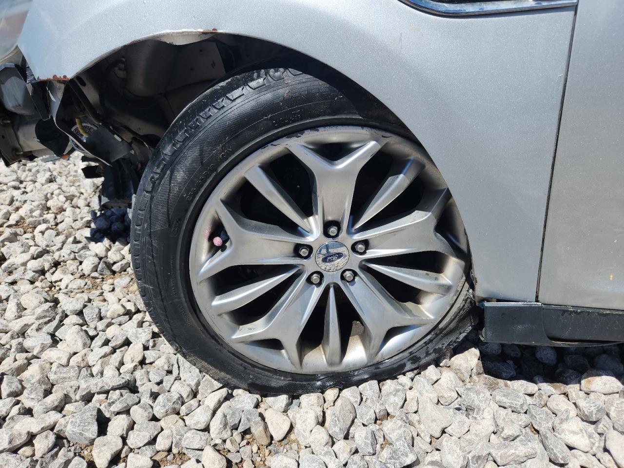 2013 Ford Taurus Silver vin: 1FAHP2F80DG200645 Damage: Left Front Wheel, Curb Rash, > 12 Inches