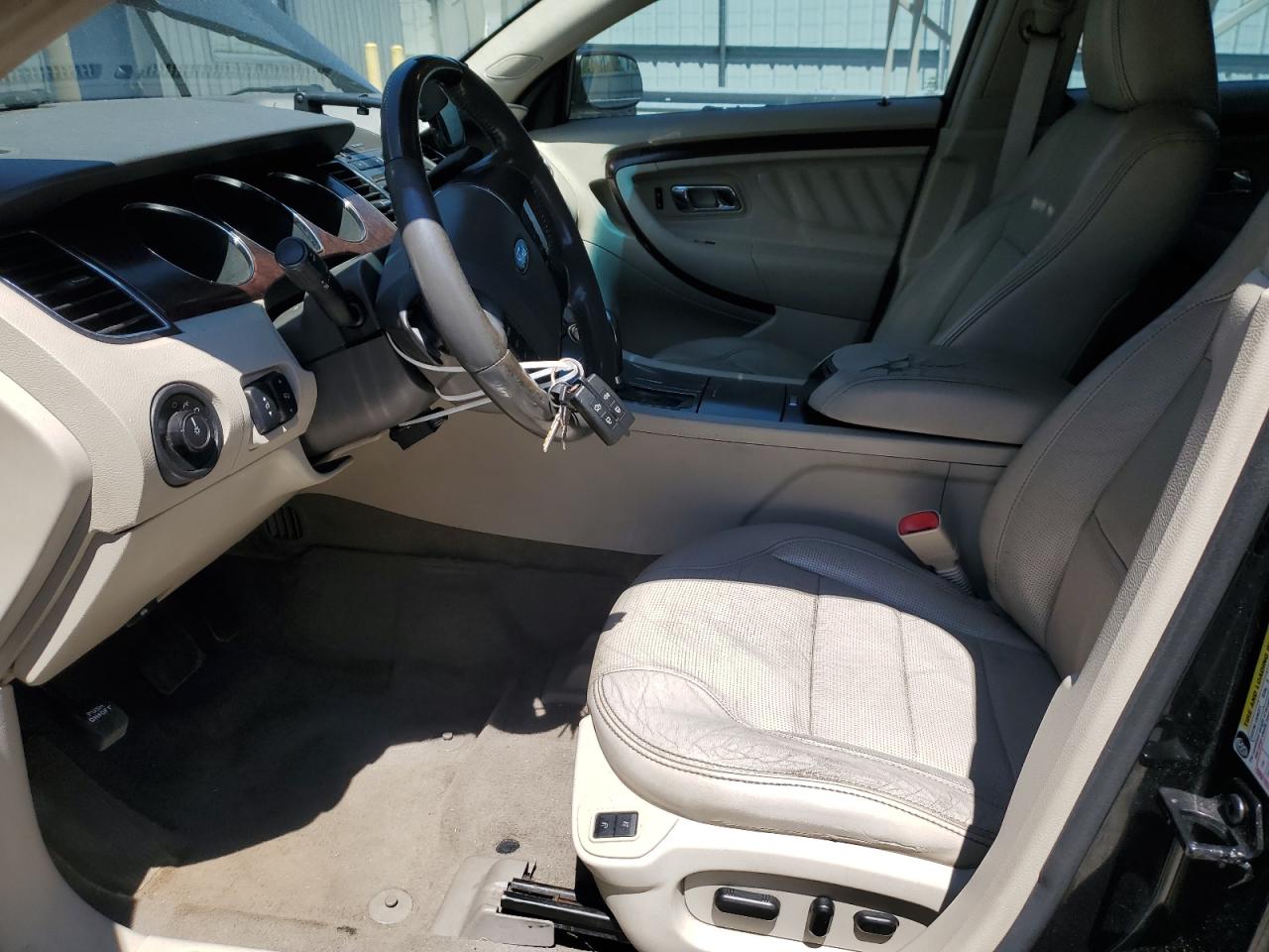 2011 Ford Taurus Limited Black vin: 1FAHP2FW1BG140385 Damage: Front Center Armrest, Cut, 3 To 4 Inches