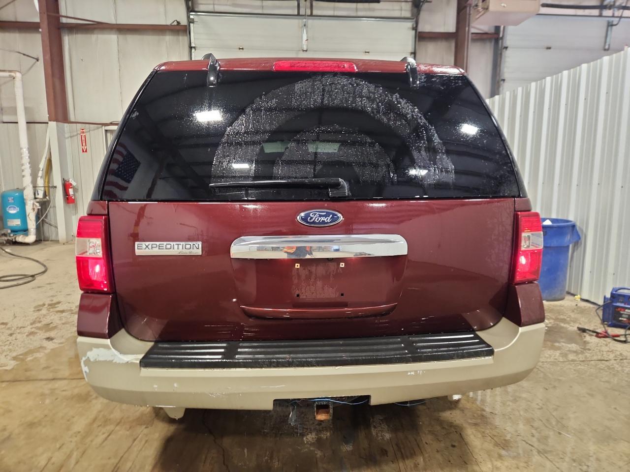 2010 Ford Expedition Eddie Bauer Burgundy vin: 1FMJU1J52AEB03462 Damage: Left Rear Bumper/Cover, Peeling, > 12 Inches