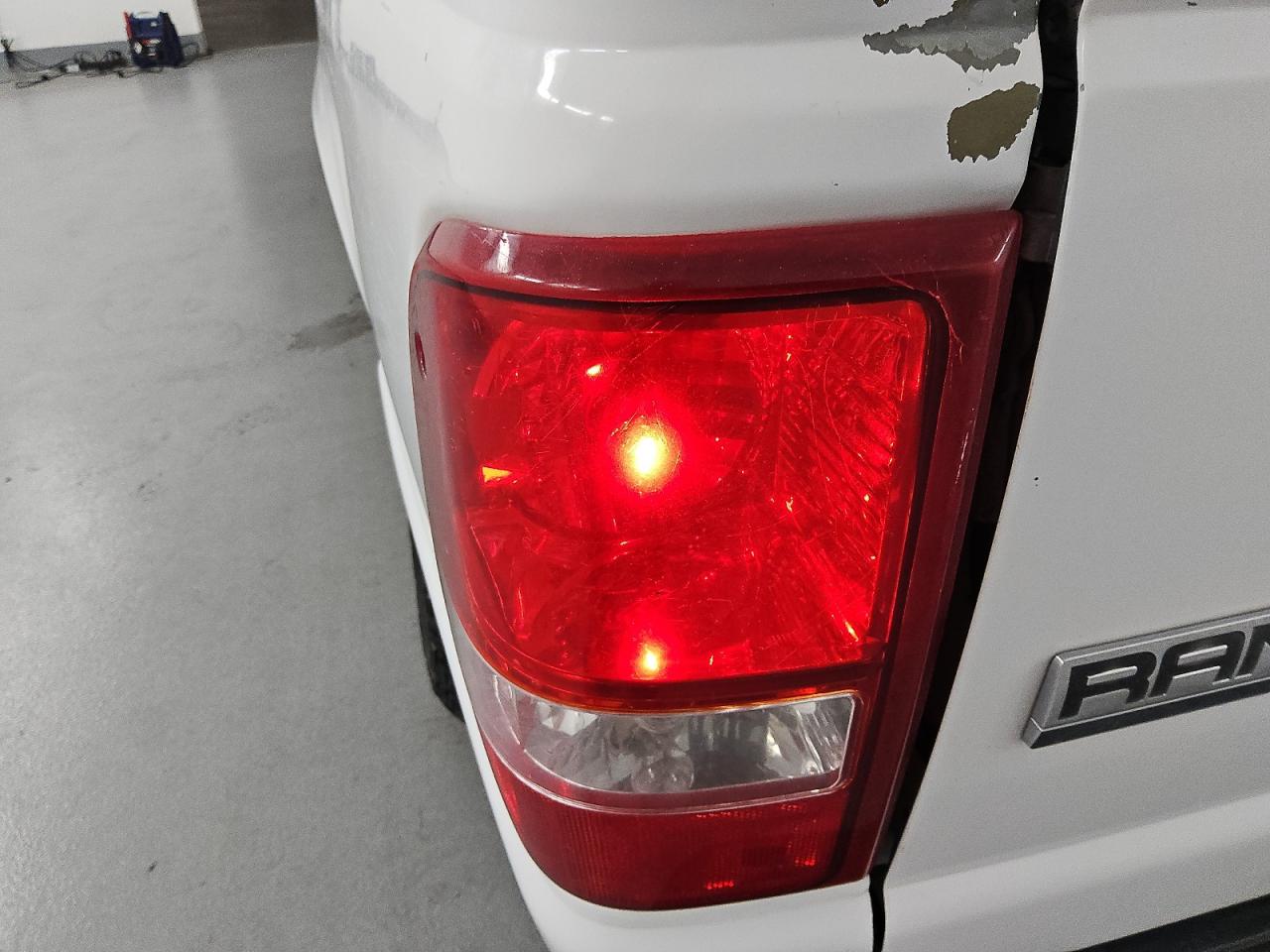 2010 Ford Ranger White vin: 1FTKR1AD0APA21946 Damage: Left Tail Light, Broken, Replacement Required