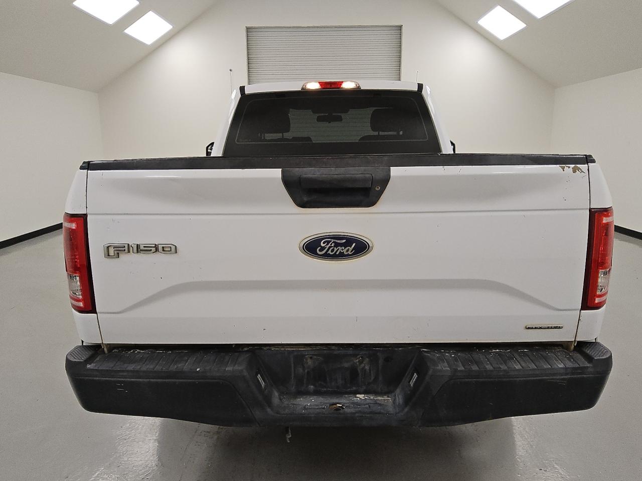 2015 Ford F150 White vin: 1FTMF1C85FKD17440 Damage: Tailgate, Peeling, 2 To 3 Inches