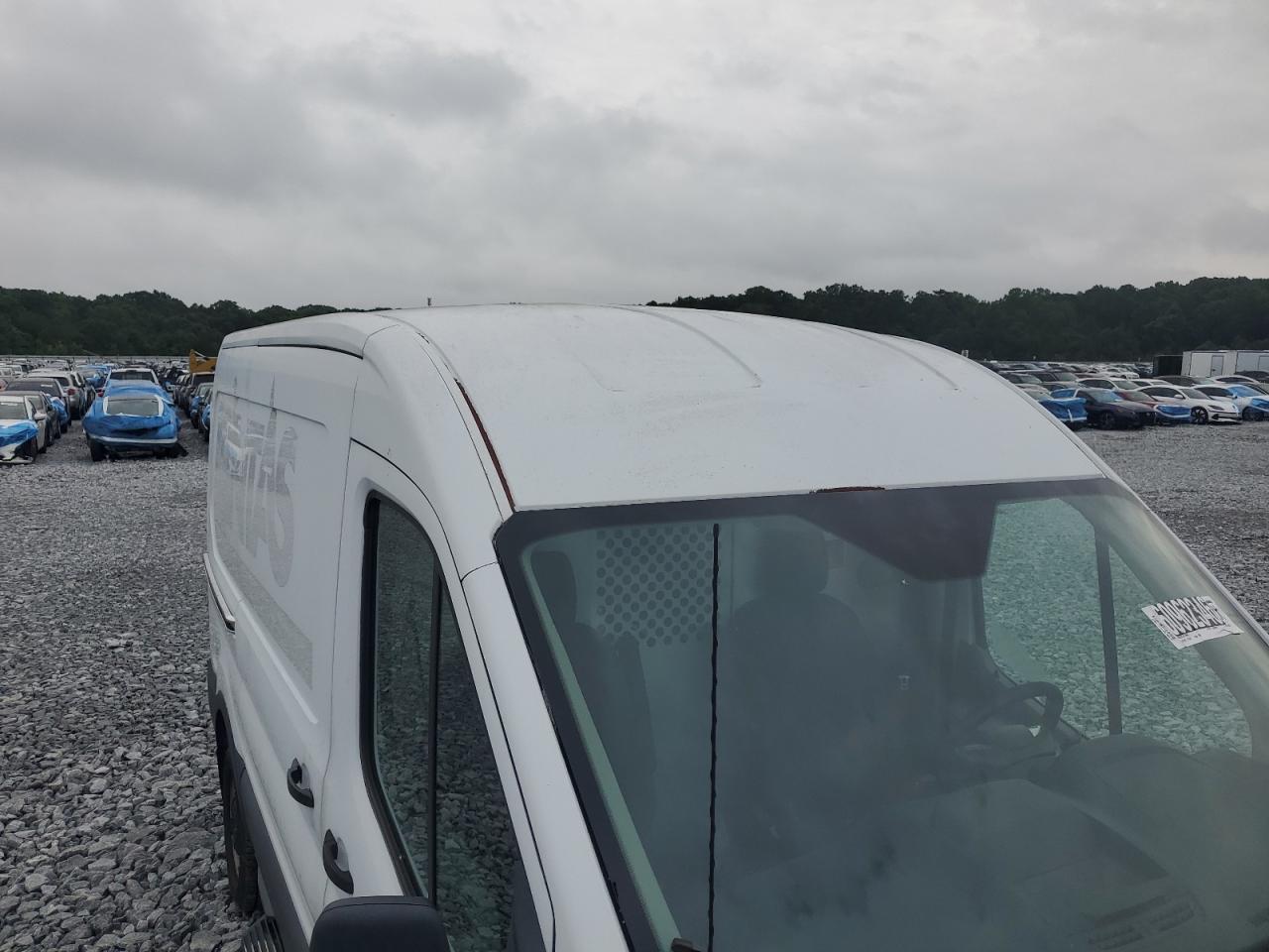2015 Ford Transit T-250 White vin: 1FTNR1CMXFKA46304 Damage: Cargo Box Roof Cap/Radius, Peeling, 9 To 10 Inches
