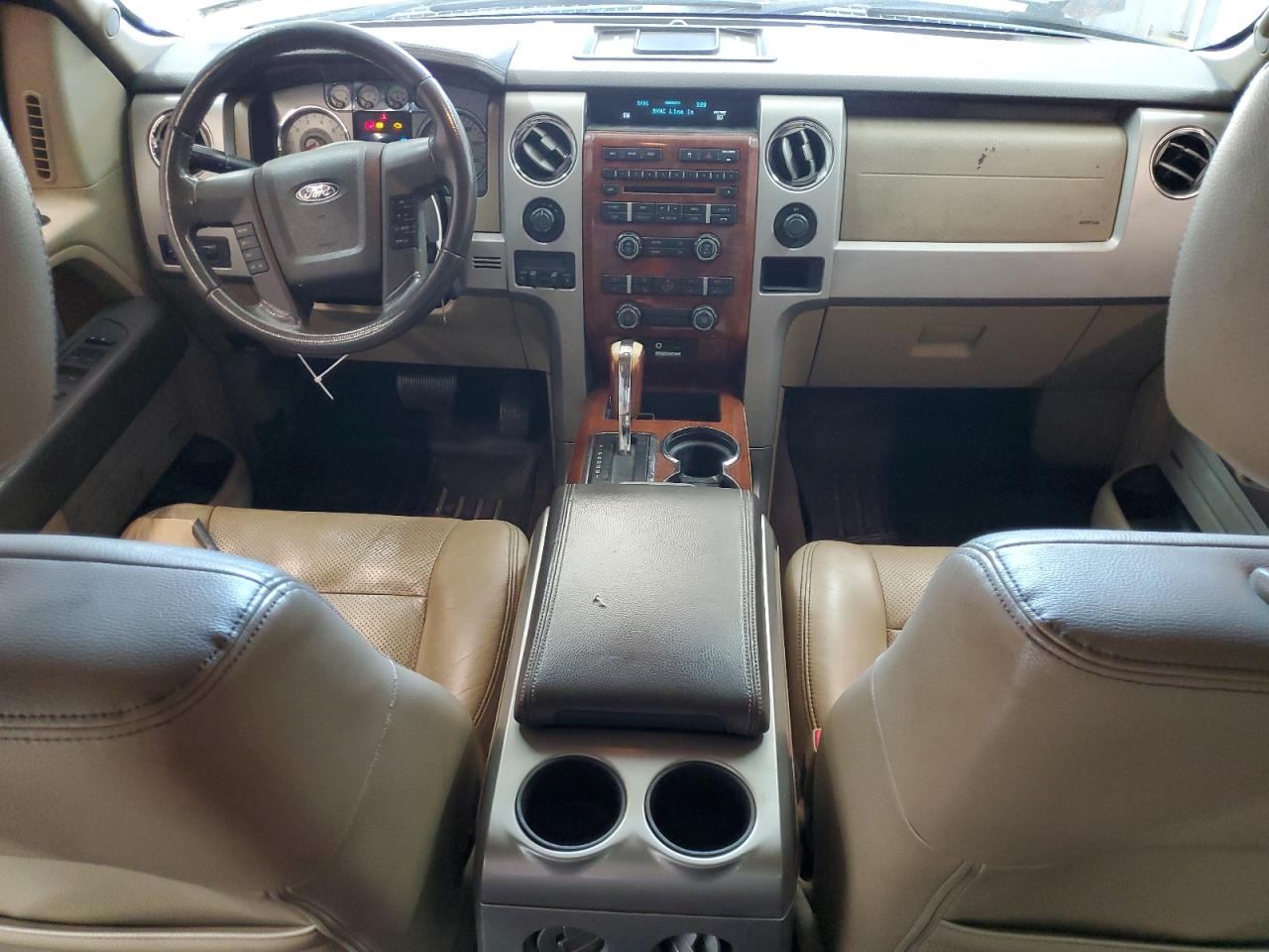 2009 Ford F150 Supercrew Brown vin: 1FTPW14V39FA95107 Damage: Front Center Armrest, Cut, 1/2 To 1 Inch