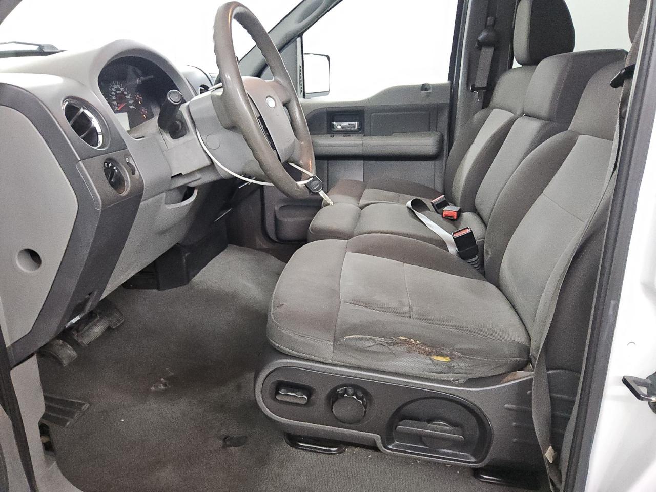 2005 Ford F150 Supercrew White vin: 1FTRW12W95FB33714 Damage: Left Front Seat Cushion, Torn, 9 To 10 Inches