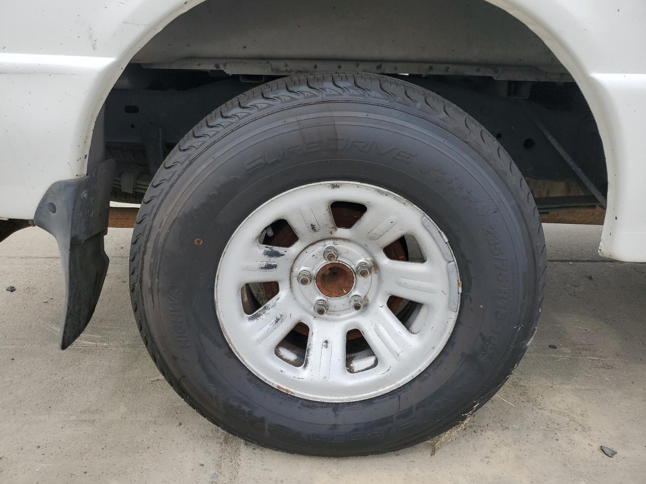 2003 Ford Ranger Super Cab White vin: 1FTYR14V93PB08620 Damage: Right Rear Center Cap, Missing, Replacement Required