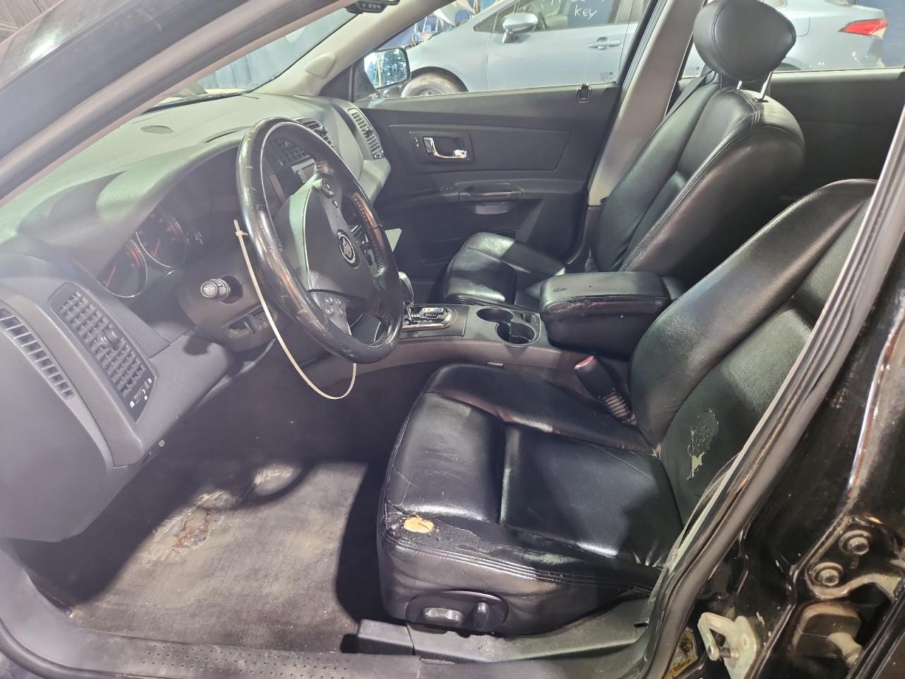 2007 Cadillac Cts Black vin: 1G6DM57T670138786 Damage: Left Front Seat, Torn, 5 To 6 Inches