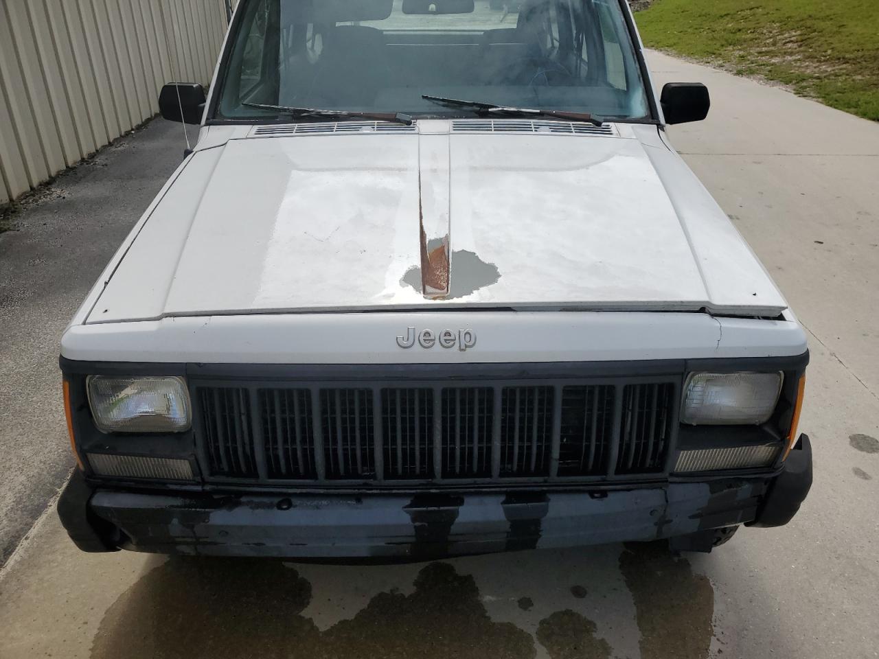 1993 Jeep Cherokee White vin: 1J4FJ28S1PL612235 Damage: Hood, Peeling, 9 to 10 inches