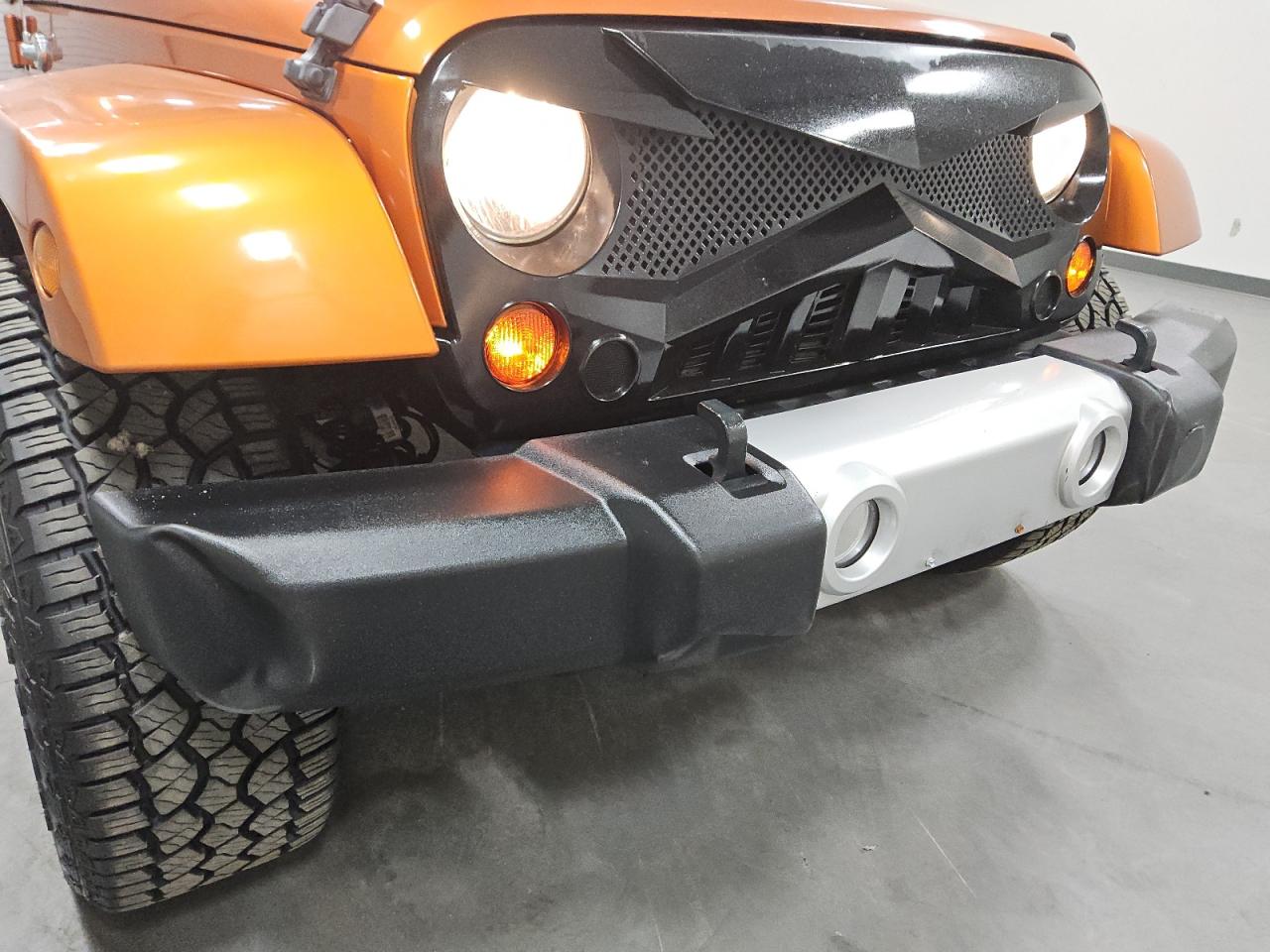 2011 Jeep Wrangler Unlimited Sahara Orange vin: 1J4HA5H11BL542536 Damage: Grille, Aftermarket, Acceptable