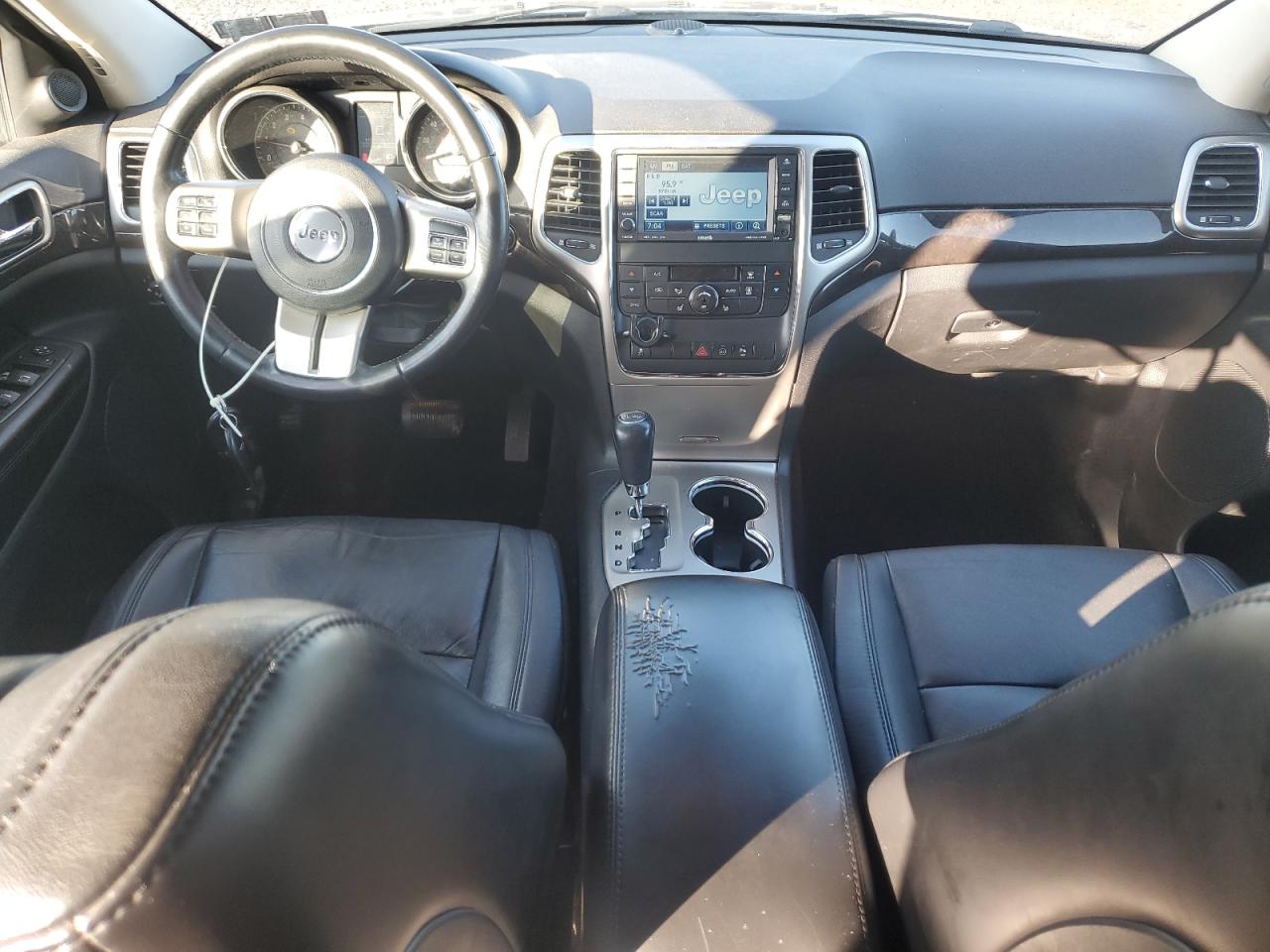 2011 Jeep Grand Cherokee Laredo Charcoal vin: 1J4RR4GG2BC657630 Damage: Console Cover, Torn, 4 To 5 Inches
