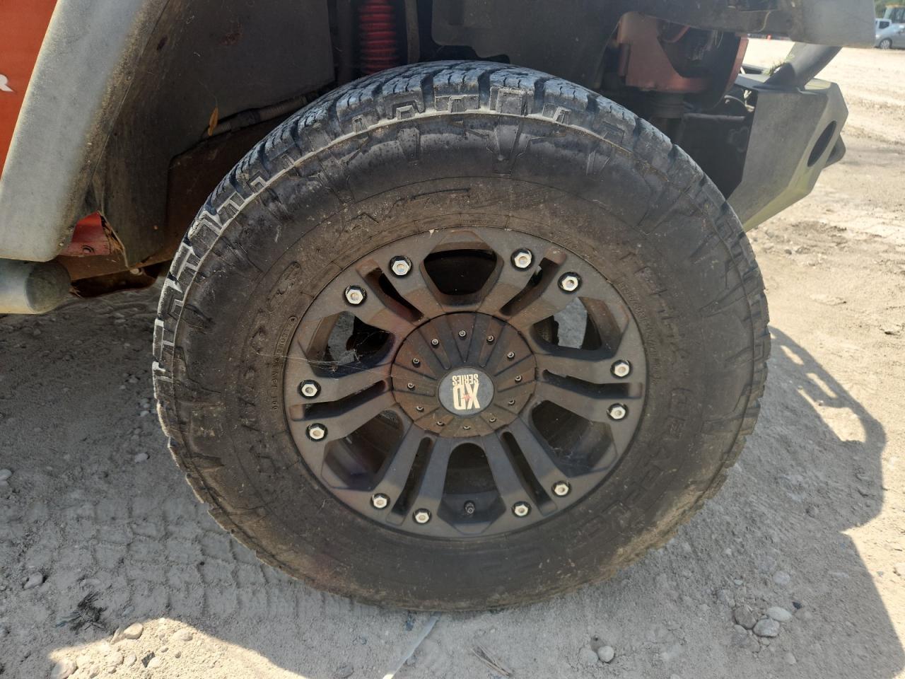2009 Jeep Wrangler Unlimited Rubicon Orange vin: 1J8GA69169L707666 Damage: Right Front Wheel, Aftermarket, Acceptable