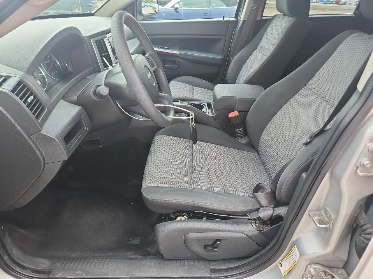 2008 Jeep Grand Cherokee Laredo Silver vin: 1J8GR48K08C244705 Damage: Left Front Seat Molding, Broken, Replacement Required