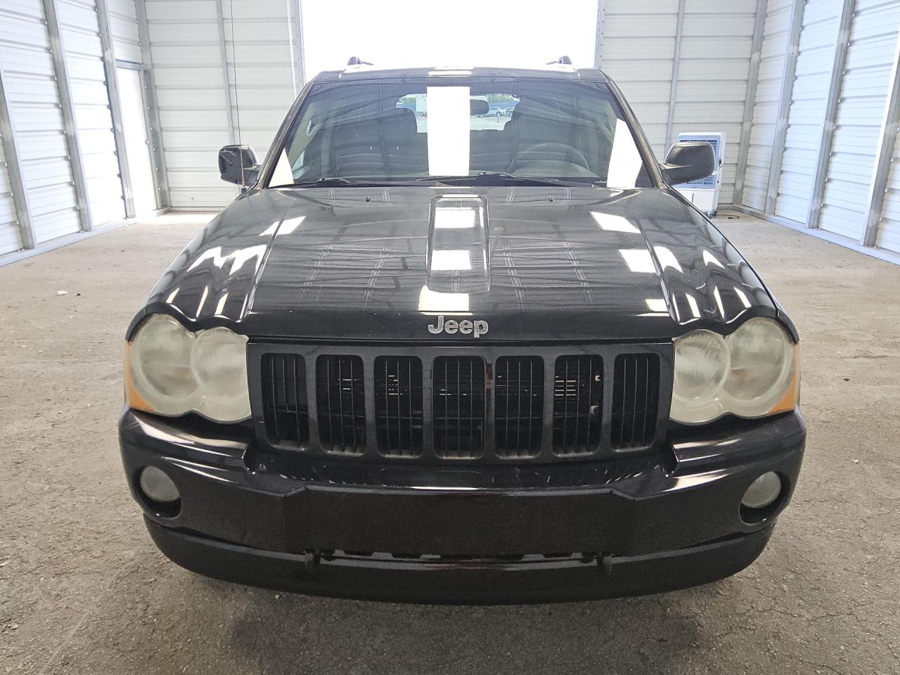 2007 Jeep Grand Cherokee Laredo Black vin: 1J8GR48K57C619616 Damage: Left Head Lamp, Faded, Repair Required