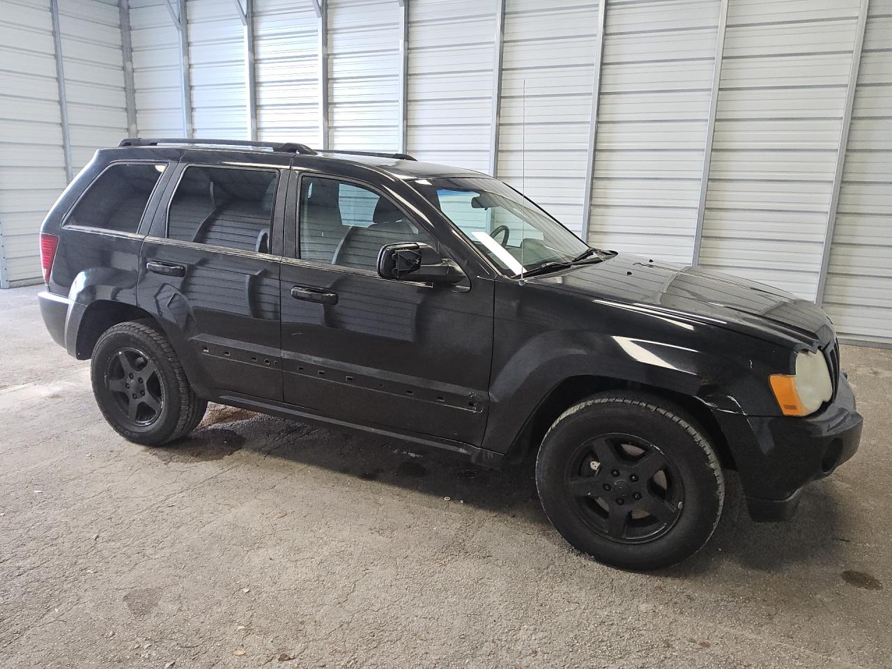 2007 Jeep Grand Cherokee Laredo Black vin: 1J8GR48K57C619616 Damage: Right Front Door Cladding, Missing, Replacement Required