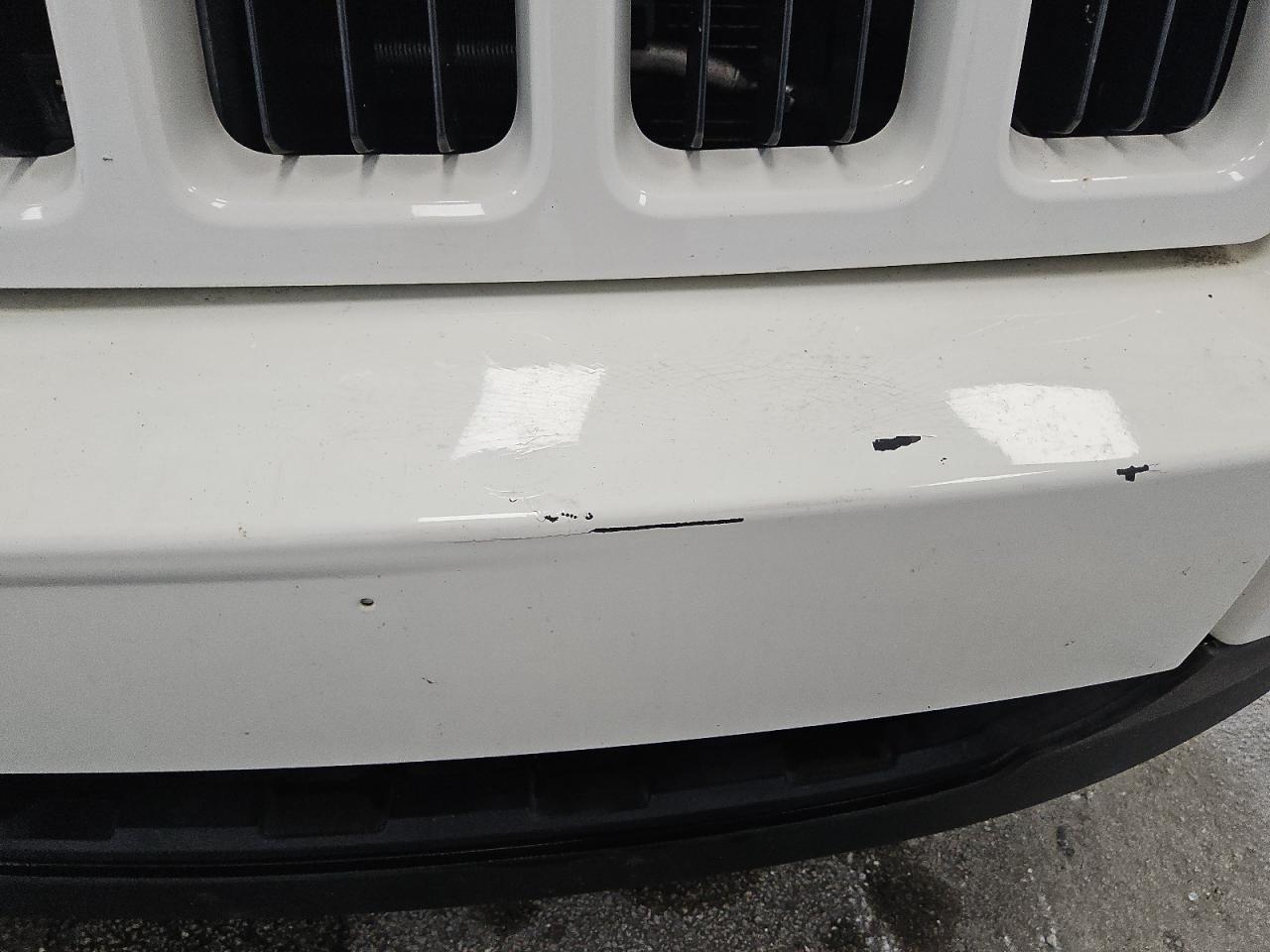 2009 Jeep Grand Cherokee Laredo White vin: 1J8GS48K59C538302 Damage: Front Bumper, Cracked Paint, 5 To 6 Inches