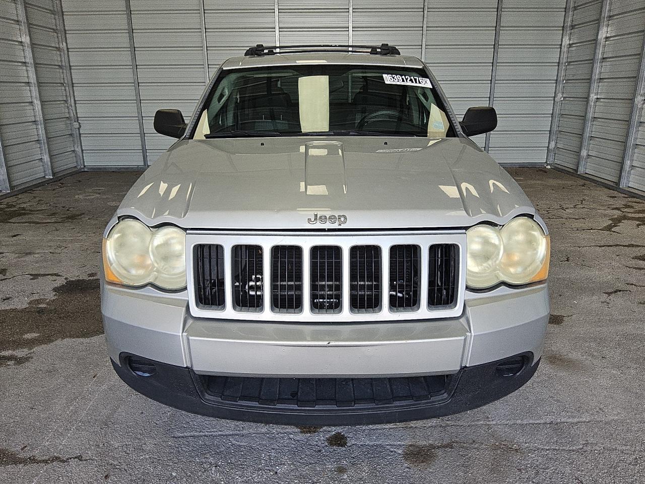 2009 Jeep Grand Cherokee Laredo Silver vin: 1J8GS48KX9C521110 Damage: Left Head Lamp, Faded, Acceptable
