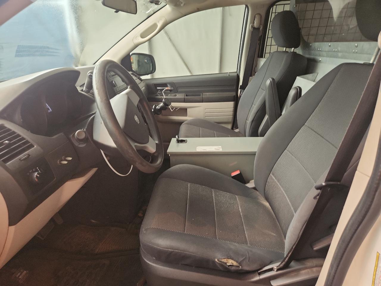 2009 Dodge Grand Caravan C/v White vin: 2D4HN11E79R611119 Damage: Left Front Seat, Worn, Replacement Required