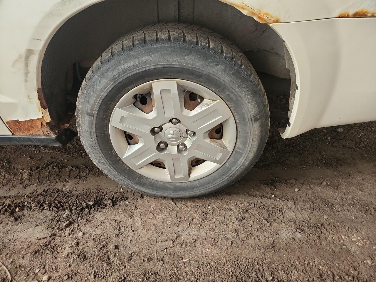 2009 Dodge Grand Caravan C/v White vin: 2D4HN11E79R611119 Damage: Left Rear Wheel Cover, Broken, Replacement Required