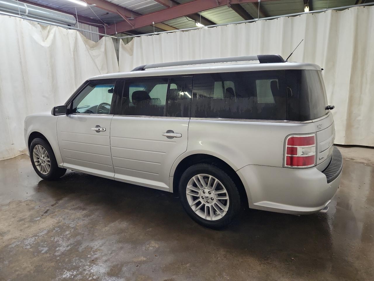 2015 Ford Flex Sel Silver vin: 2FMGK5C82FBA18963 Damage: Left Qtr Panel, Dent(S) W/ Paint Dmg, 1/2 To 1 Inch