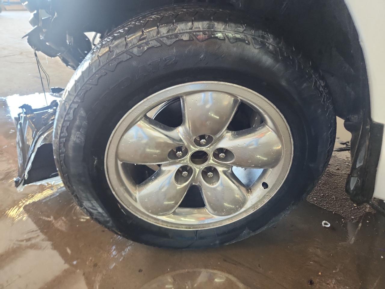 2013 Ram 1500 St White vin: 3C6JR6AT5DG583681 Damage: Left Front Center Cap, Missing, Replacement Required