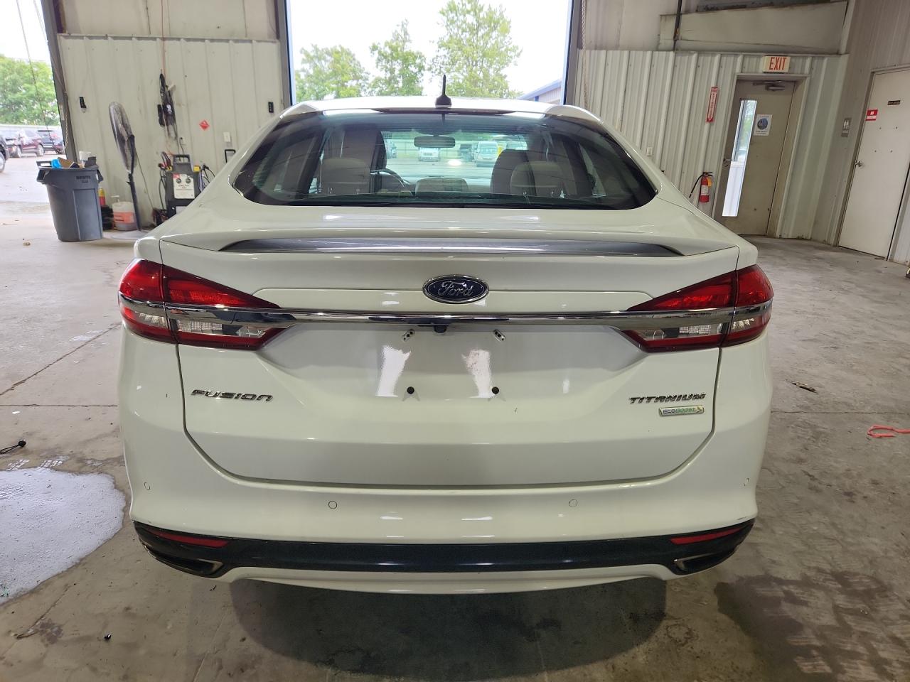 2017 Ford Fusion Titanium White vin: 3FA6P0K93HR131409 Damage: Rear Bumper, Heavy Scratch, 1/2 To 1 Inch
