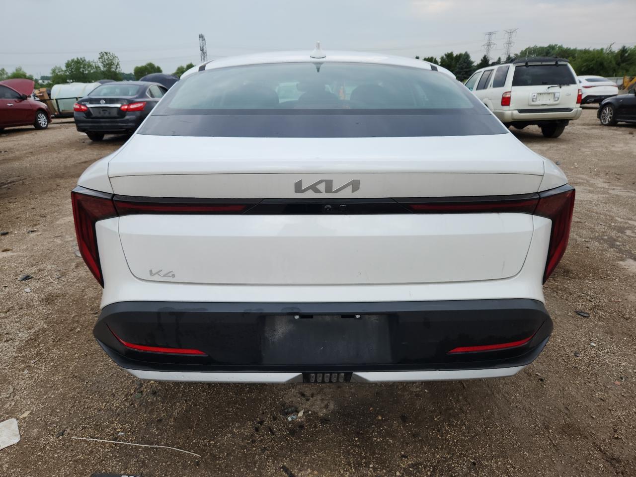 2025 Kia K4 Lxs White vin: 3KPFT4DE2SE085304 Damage: Rear Bumper, Multiple Scratches Light, 3