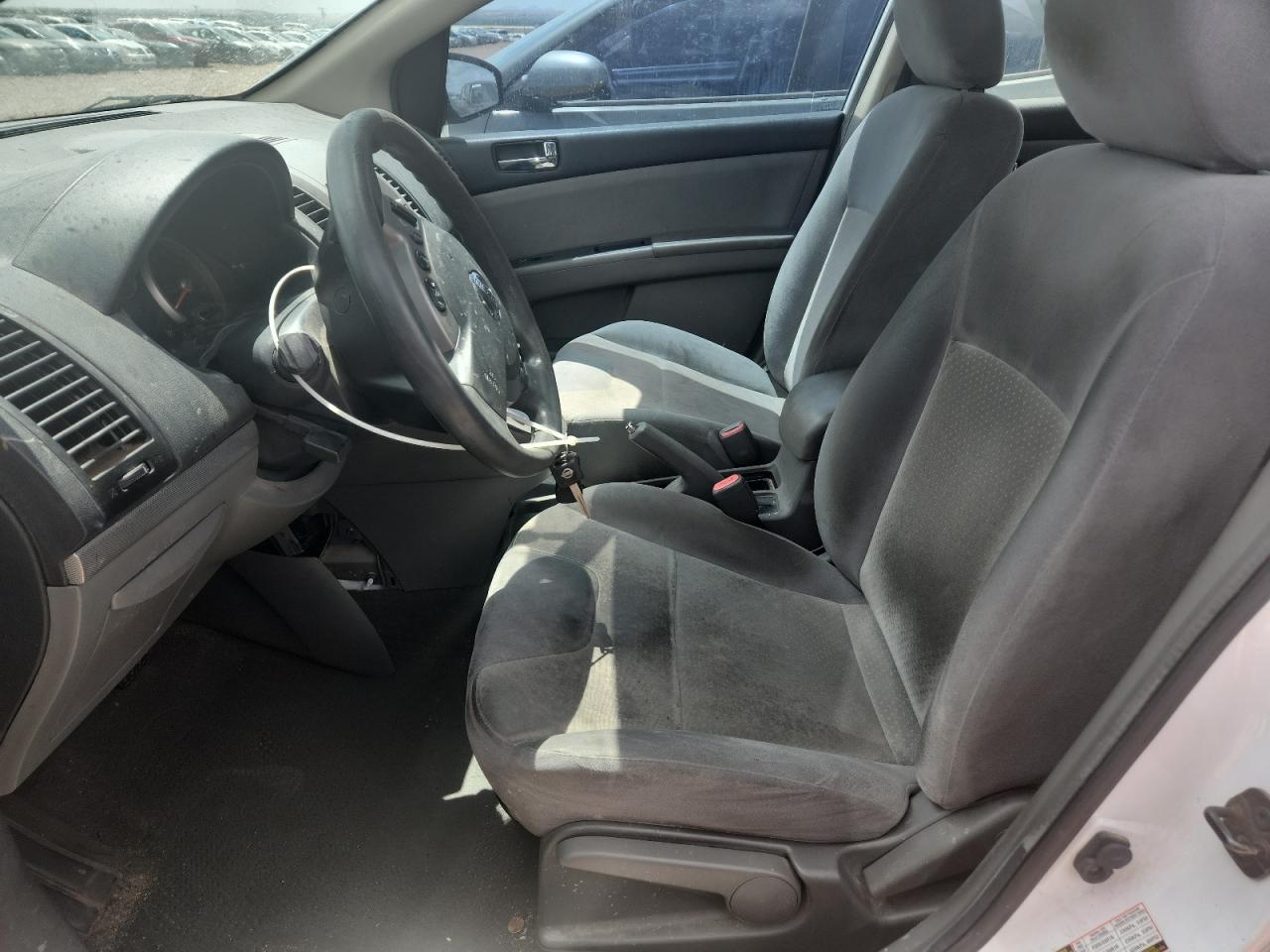 2009 Nissan Sentra 2.0 White vin: 3N1AB61E99L647236 Damage: Left Front Seat, Stained, Permanent