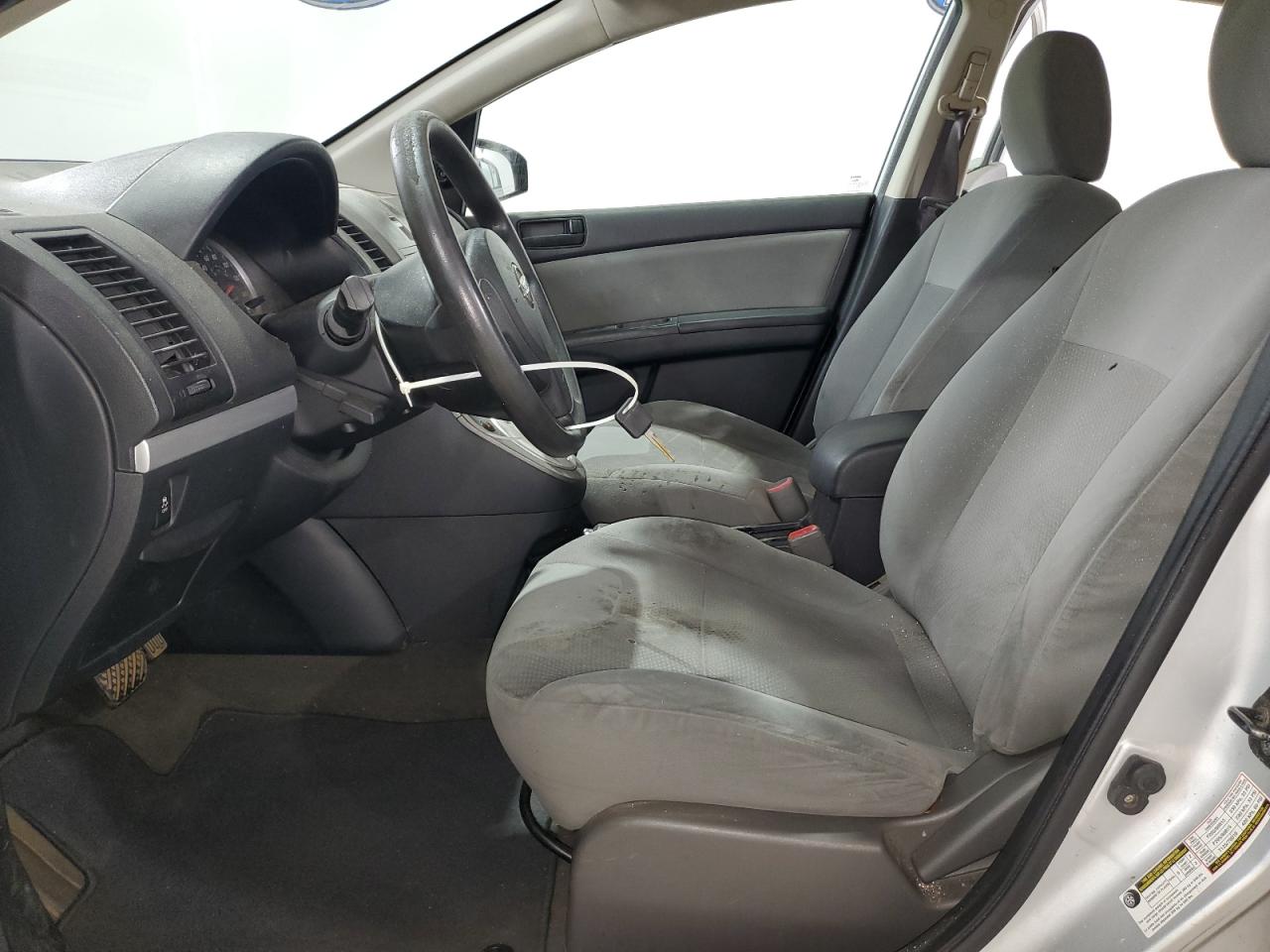 2012 Nissan Sentra 2.0 Silver vin: 3N1AB6AP9CL659735 Damage: Left Front Seat, Burn Hole, 1/8 To 1/2 Inch