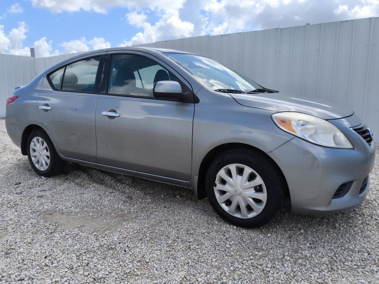 2014 Nissan Versa 1.6 S Silver vin: 3N1CN7APXEL829237 Damage: Right Front Wheel Cover, Broken, Replacement Required