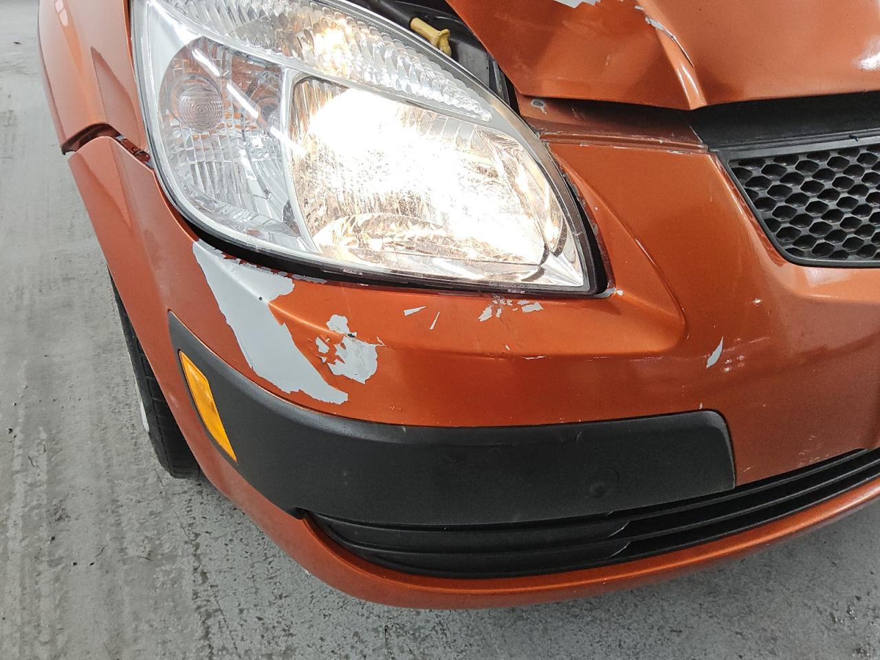 2009 Kia Rio5 Lx Orange vin: KNADE243896567101 Damage: Front Bumper, Peeling, > 12 Inches