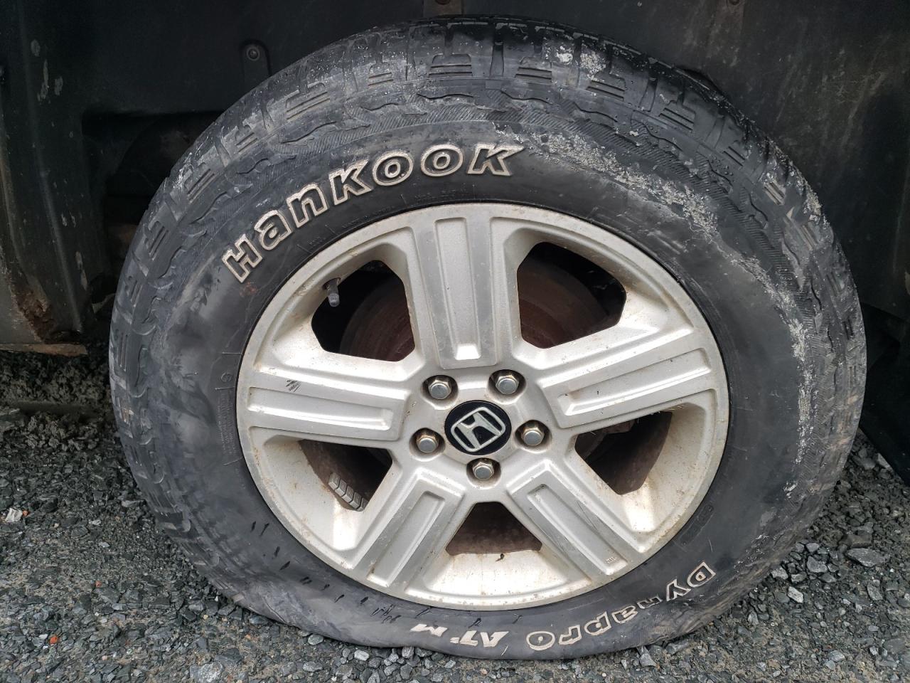 2010 Honda Ridgeline Rtl Gold vin: 5FPYK1F57AB501449 Damage: Left Rear Tire, Cut, Replacement Required