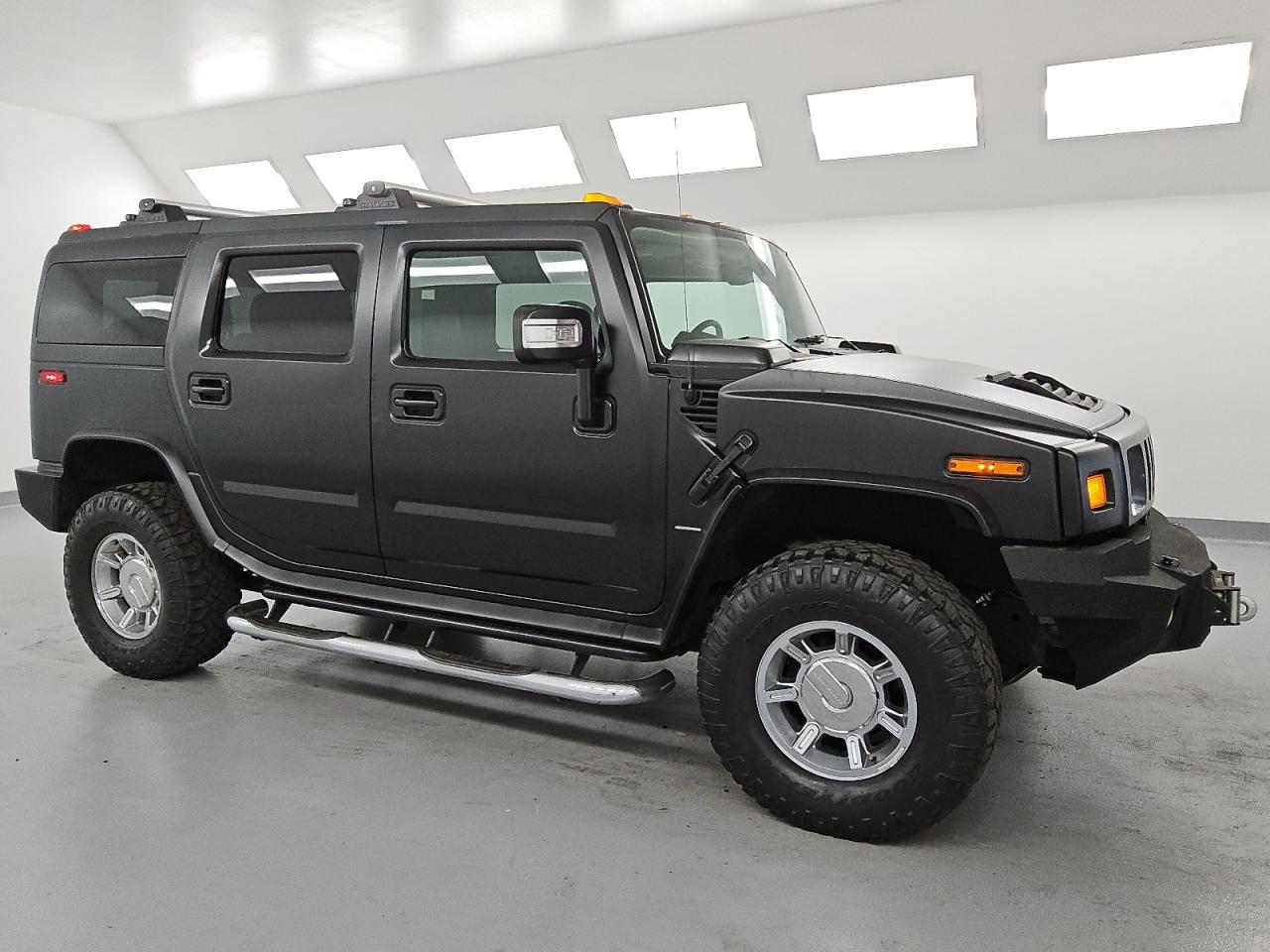 2006 Hummer H2 Black vin: 5GRGN23UX6H102182 Damage: Front Bumper, Aftermarket, Acceptable