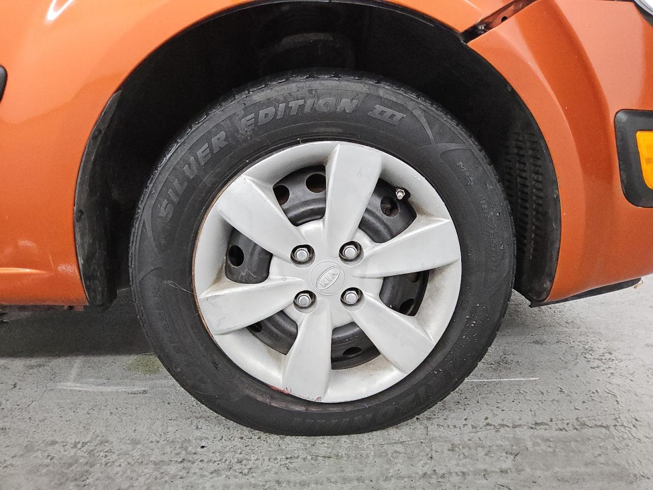2009 Kia Rio5 Lx Orange vin: KNADE243896567101 Damage: Right Front Wheel Cover, Bent, Replacement Required