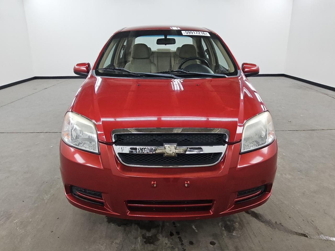 2011 Chevrolet Aveo Red vin: KL1TD5DE9BB220532 Damage: Grille Molding, Peeling, 7 To 8 Inches
