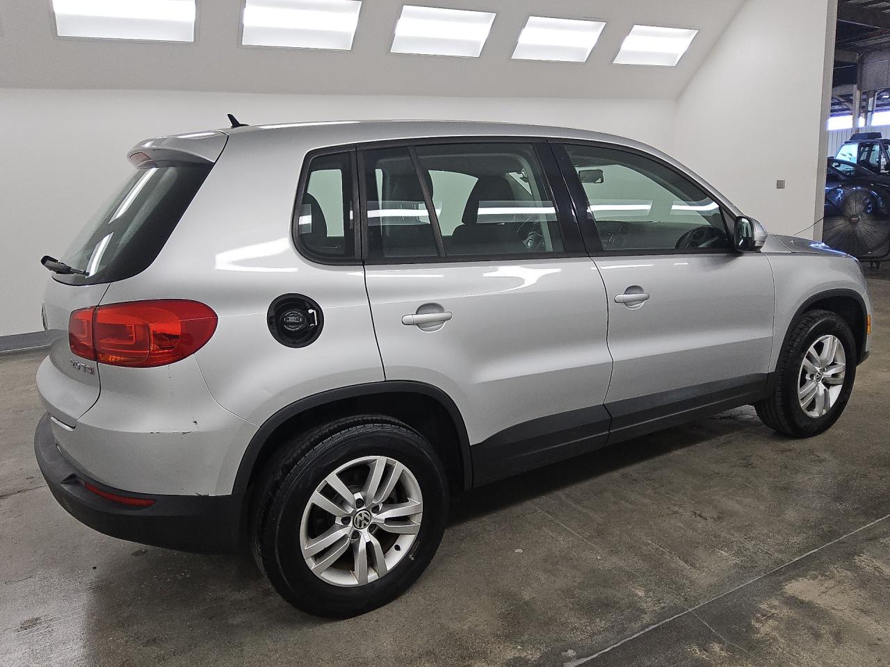 2014 Volkswagen Tiguan S Silver vin: WVGAV3AX9EW603354 Damage: Right Fuel Door, Broken, Replacement Required