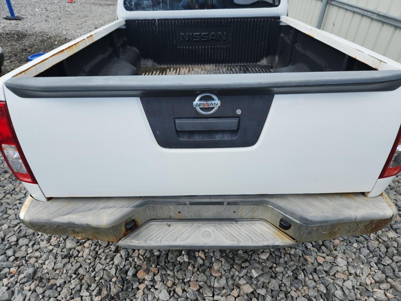 2015 Nissan Frontier S White vin: 1N6BD0CT8FN735479 Damage: Rear Metal Bumper Chrome, Rust, Severe Damage