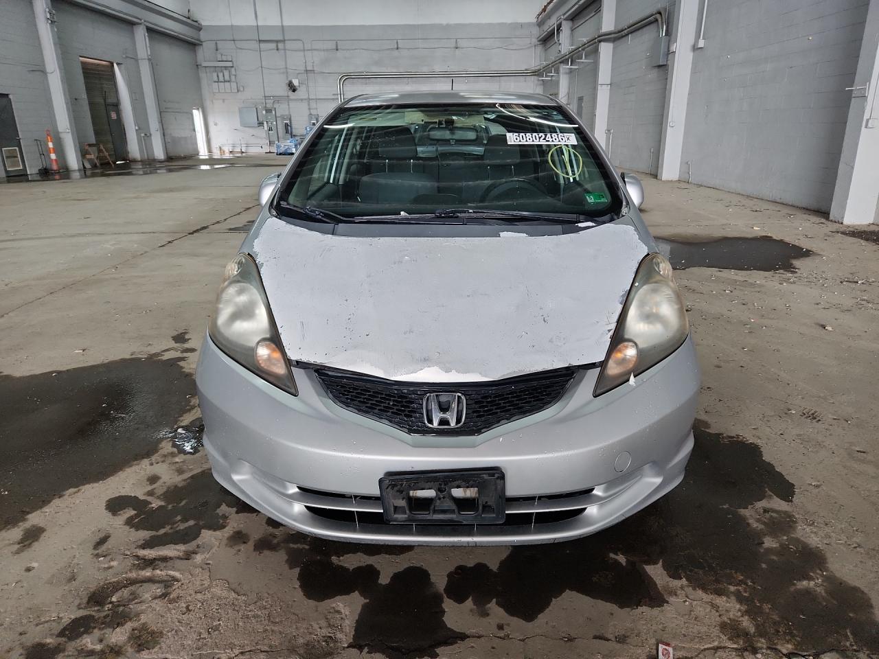2012 Honda Fit Серебряный vin: JHMGE8H34CS003598 Damage: Hood, Peeling, > 12 Inches