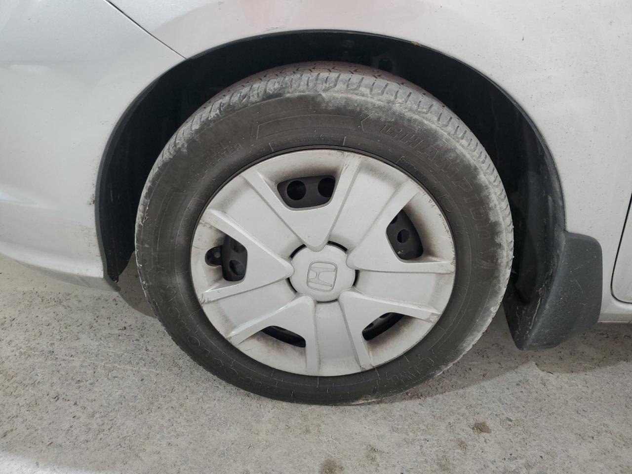 2013 Honda Fit Silver vin: JHMGE8H34DC007906 Damage: Left Front Wheel Cover, Curb Rash, > 12 Inches
