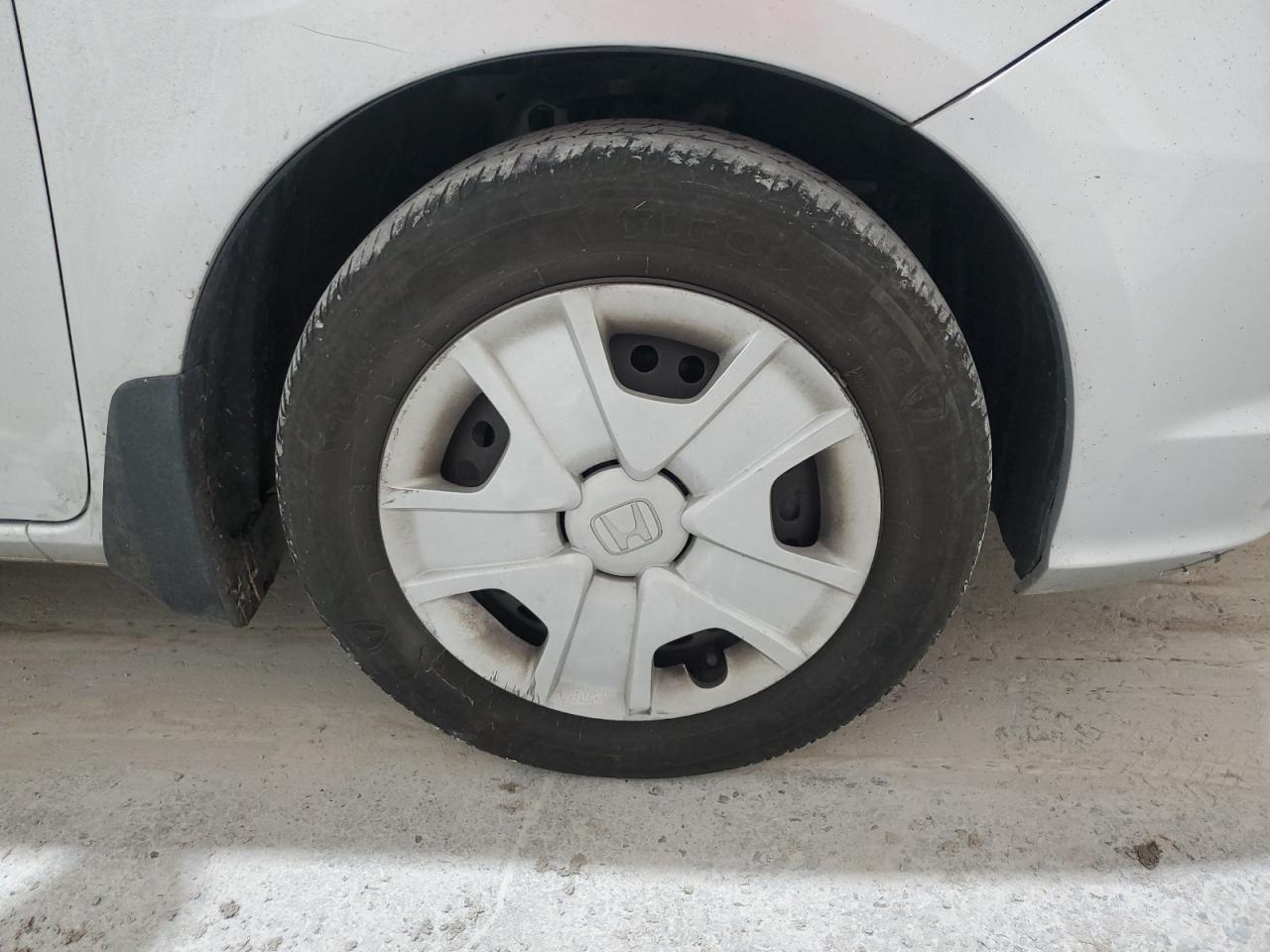 2013 Honda Fit Silver vin: JHMGE8H34DC007906 Damage: Right Front Wheel Cover, Curb Rash, > 12 Inches