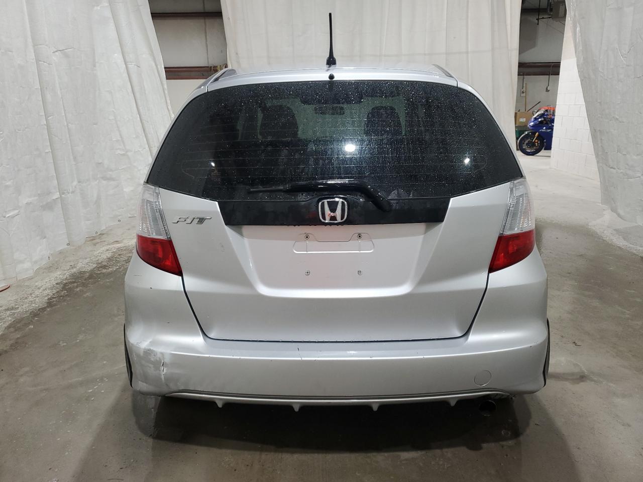 2013 Honda Fit Silver vin: JHMGE8H34DC007906 Damage: Rear Bumper, Broken, Replacement Required