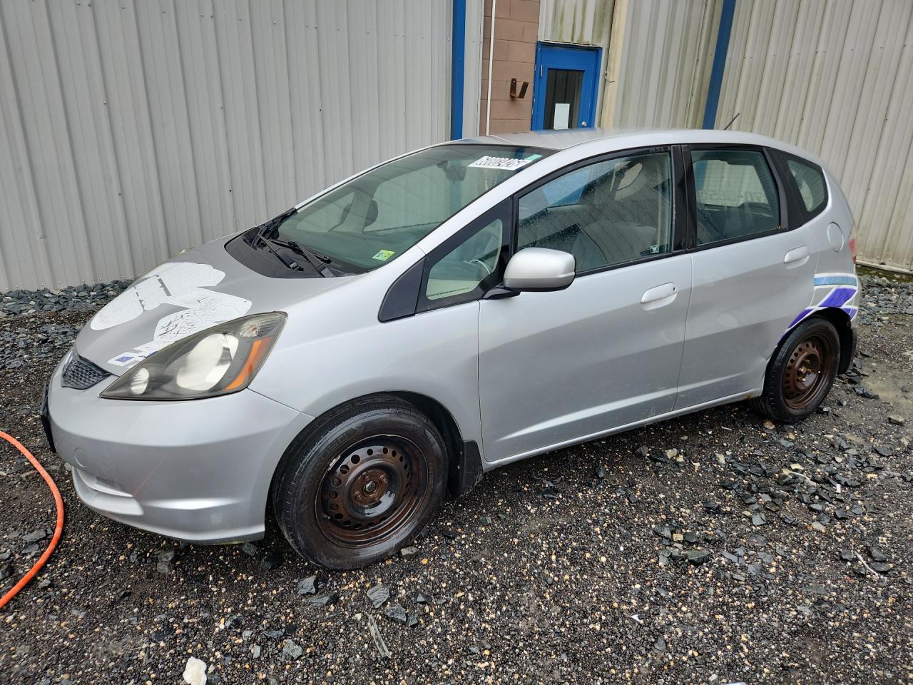 2012 Honda Fit Silver vin: JHMGE8H38CS002129 Damage: Left Front Wheel Cover, Broken, Replacement Required