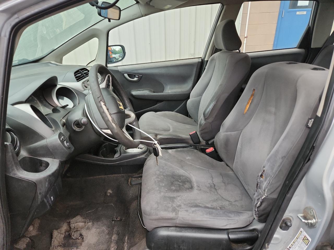 2012 Honda Fit Silver vin: JHMGE8H38CS002129 Damage: Left Front Seat, Torn, 1 To 2 Inches