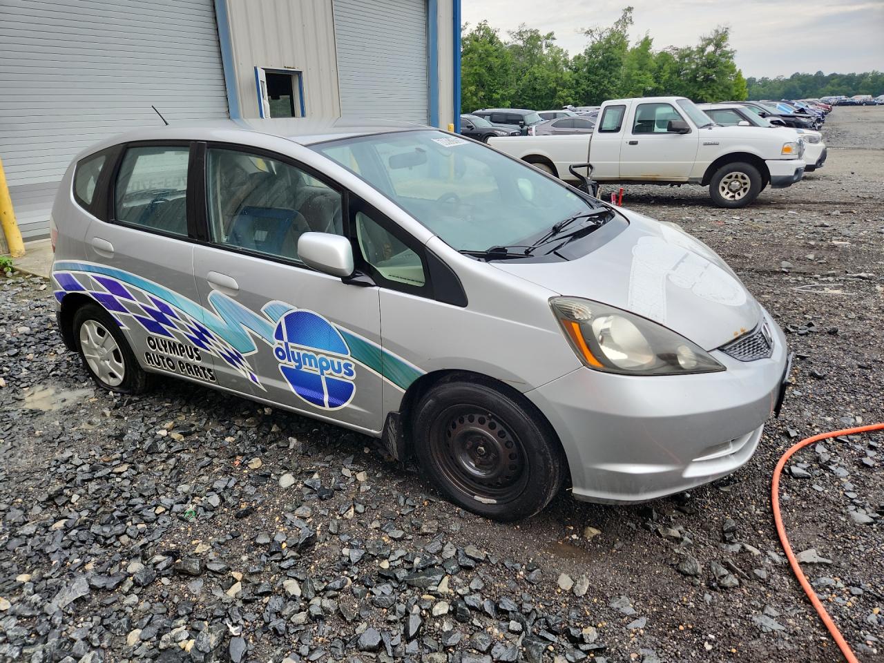 2012 Honda Fit Silver vin: JHMGE8H38CS002129 Damage: Right Front Wheel Cover, Broken, Replacement Required