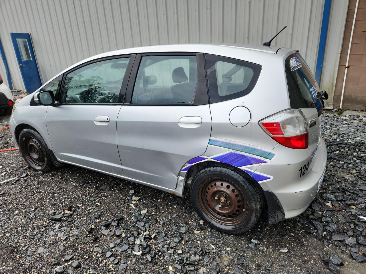2012 Honda Fit Silver vin: JHMGE8H38CS002129 Damage: Left Rear Door, Severe Damage, Replacement Required