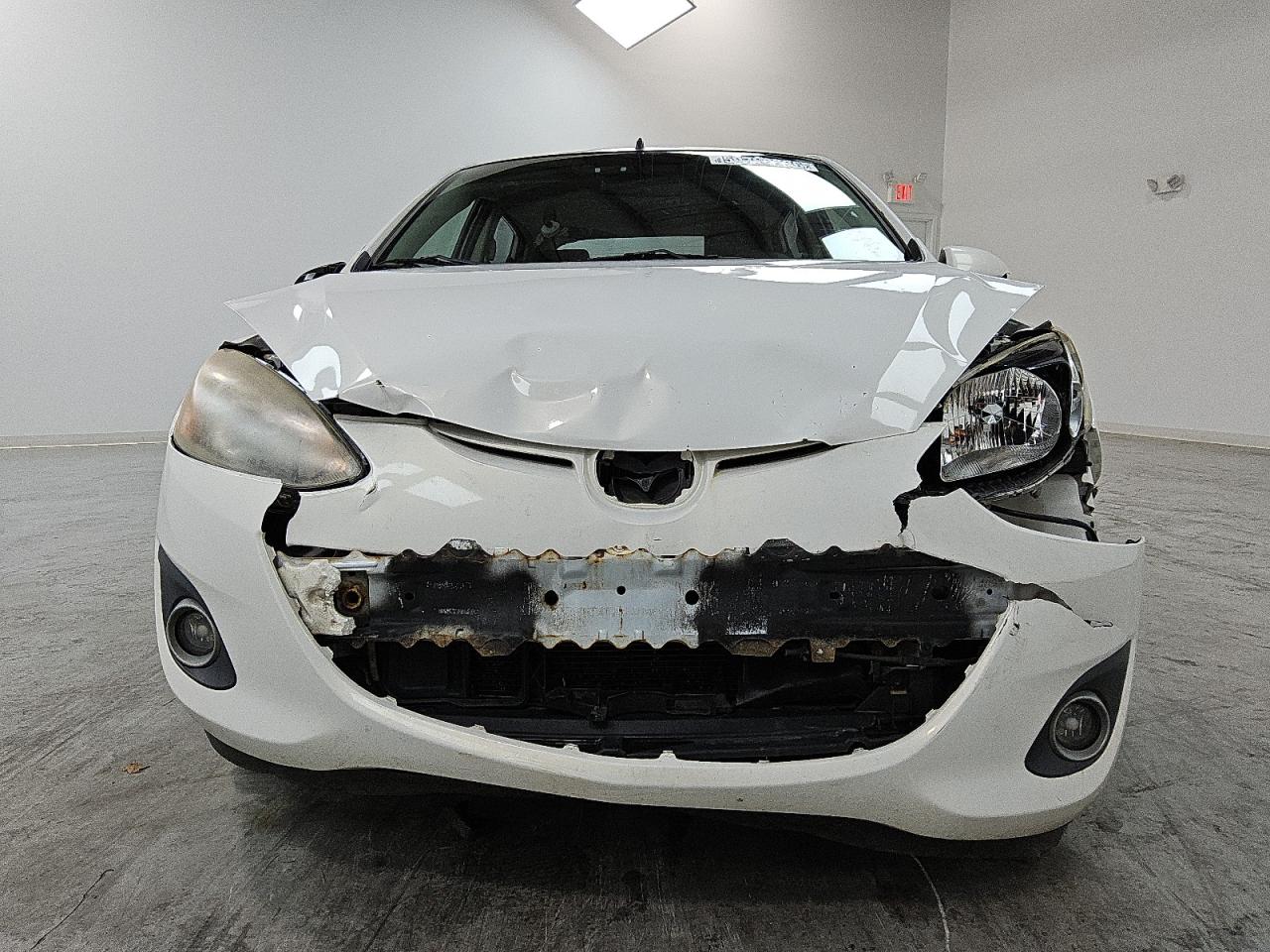 2011 Mazda Mazda2 White vin: JM1DE1HY9B0102998 Damage: Front Bumper/Cover, Broken, Replacement Required