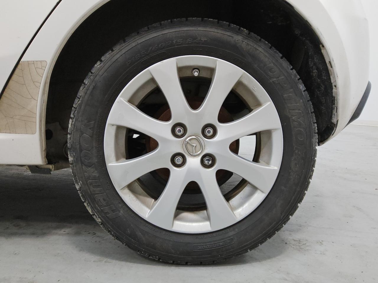 2011 Mazda Mazda2 White vin: JM1DE1HY9B0102998 Damage: Left Rear Wheel, Curb Rash, 1 To 2 Inches