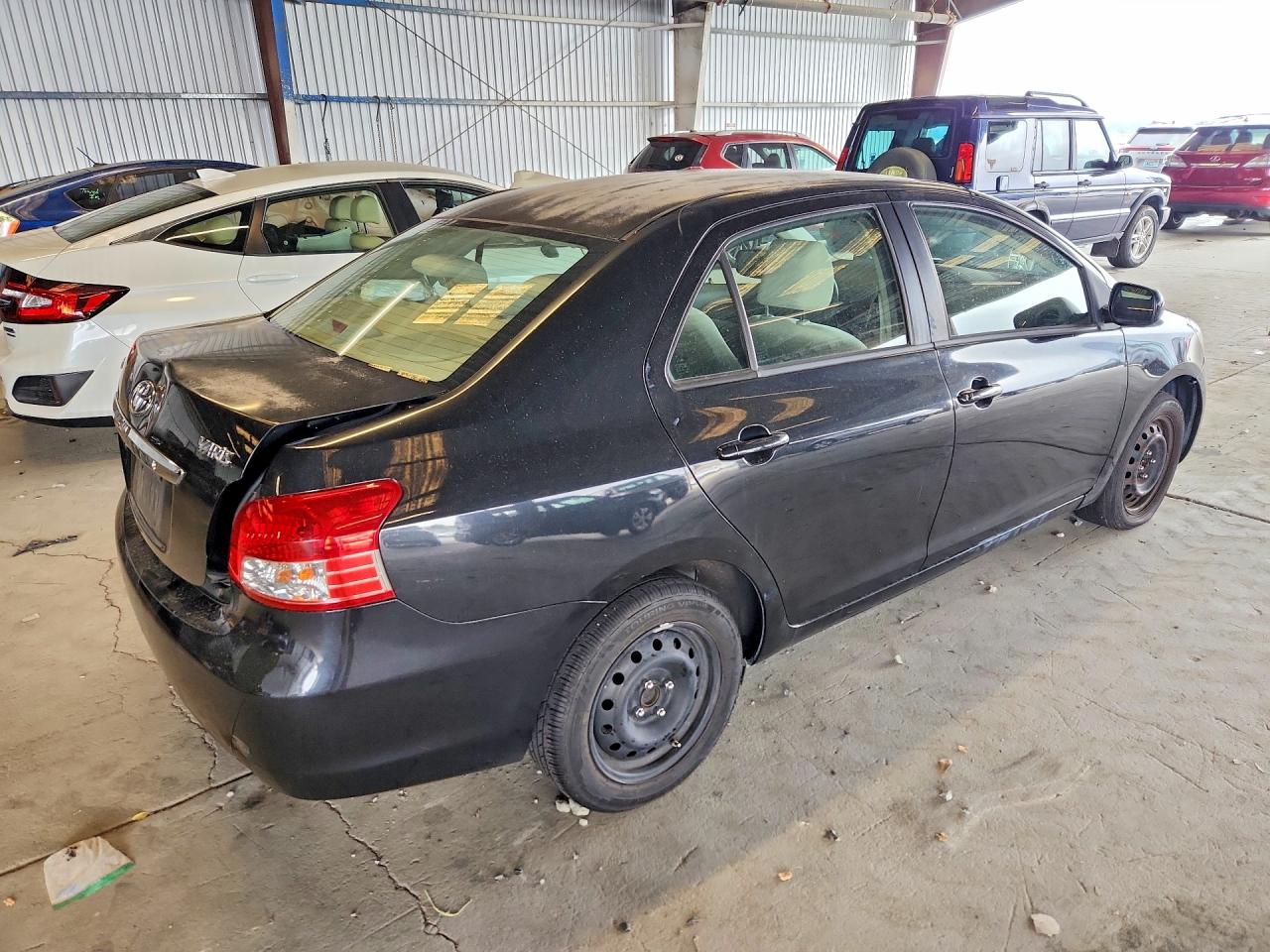 2009 Toyota Yaris Base Black vin: JTDBT903791299055