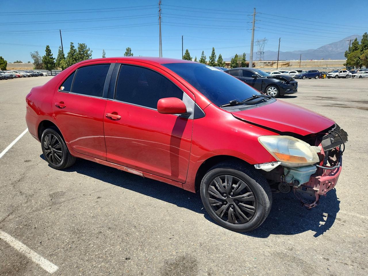2009 Toyota Yaris Base Red vin: JTDBT903791339571